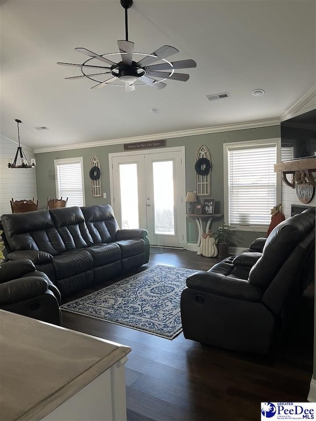 living room with crown molding and a healthy amount of sunlight