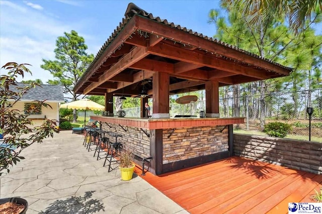 deck featuring fence and a gazebo