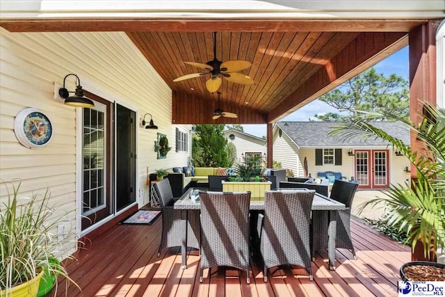 wooden deck featuring french doors, outdoor lounge area, outdoor dining area, and ceiling fan