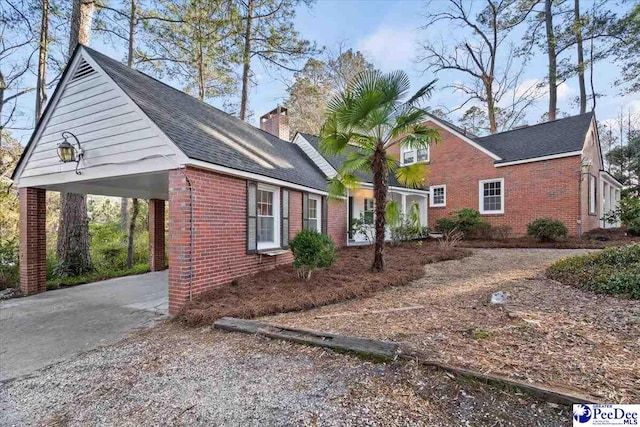 view of side of property with a carport