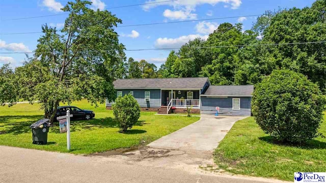 903 N Park St, Mullins, SC 29574 - view of front of home featuring a porch, driveway, a front lawn, and crawl space