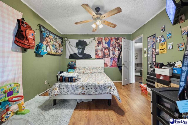 903 N Park St, Mullins, SC 29574 - bedroom with a textured ceiling, wood finished floors, and a ceiling fan
