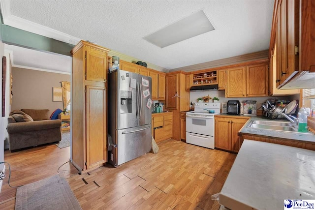 903 N Park St, Mullins, SC 29574 - kitchen with stainless steel fridge with ice dispenser, electric stove, ornamental molding, light wood finished floors, and under cabinet range hood