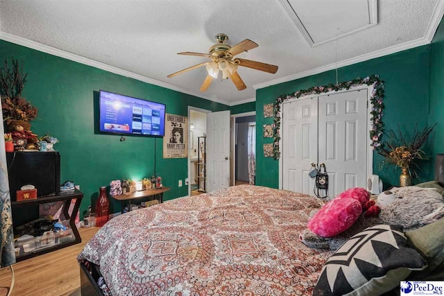 903 N Park St, Mullins, SC 29574 - bedroom with attic access, wood finished floors, a textured ceiling, a closet, and crown molding