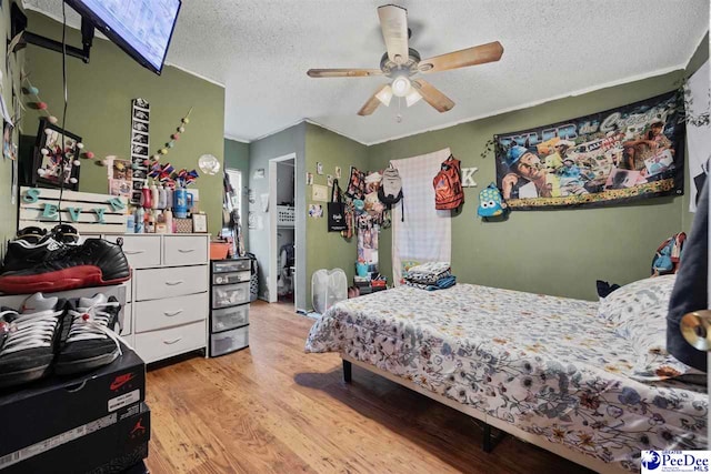 903 N Park St, Mullins, SC 29574 - bedroom featuring light wood-style floors, a textured ceiling, and ceiling fan