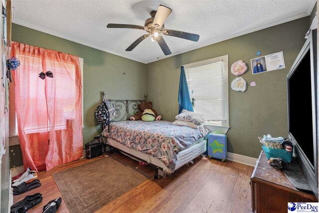 903 N Park St, Mullins, SC 29574 - bedroom with a textured ceiling, wood finished floors, ornamental molding, and a ceiling fan