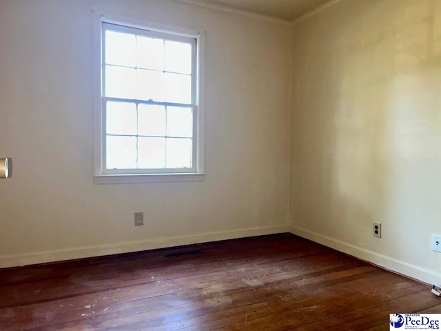 unfurnished room with crown molding and dark hardwood / wood-style floors