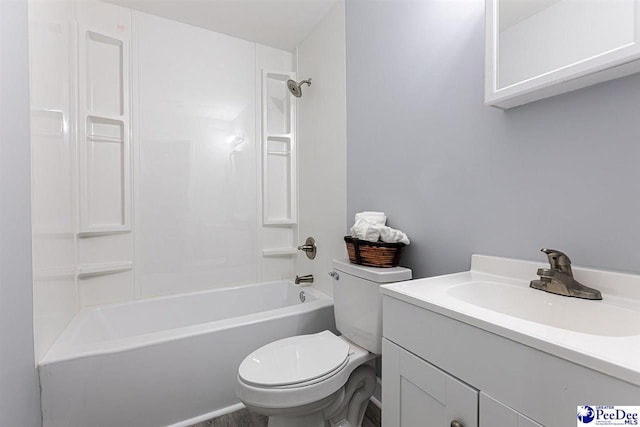 full bathroom featuring vanity, tub / shower combination, and toilet