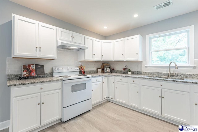 kitchen with light stone counters, sink, white cabinets, and white range with electric stovetop