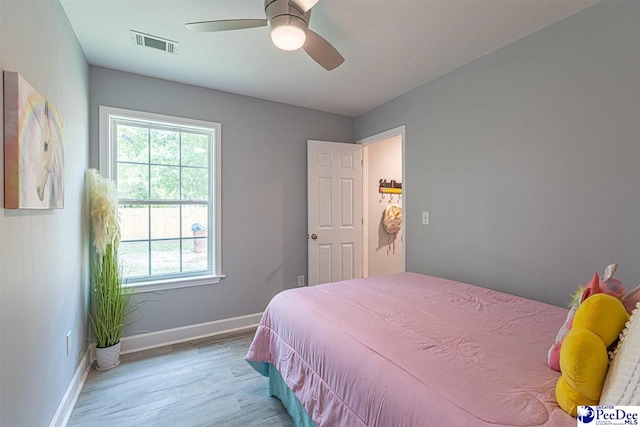 bedroom featuring light hardwood / wood-style floors and ceiling fan