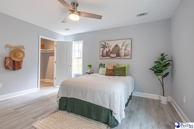 bedroom with light hardwood / wood-style floors and ceiling fan