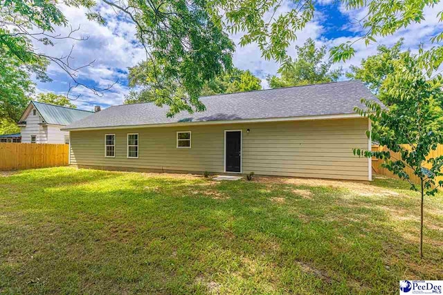 back of house featuring a yard