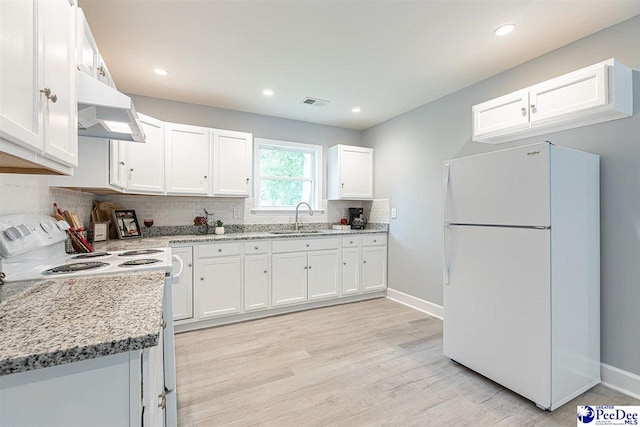 kitchen featuring sink, white cabinetry, light stone counters, white appliances, and range hood