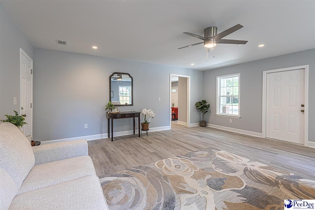 living room featuring ceiling fan and light hardwood / wood-style floors