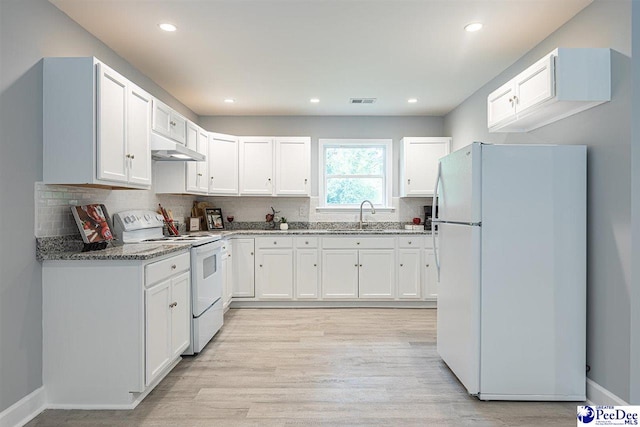 kitchen featuring sink, light hardwood / wood-style flooring, stone counters, white appliances, and white cabinets