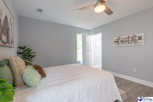 bedroom with wood-type flooring and ceiling fan