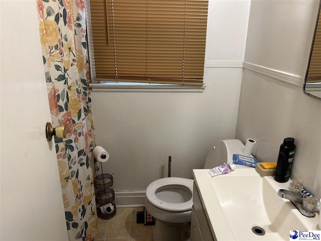 bathroom featuring a shower with shower curtain, toilet, vanity, and tile patterned flooring