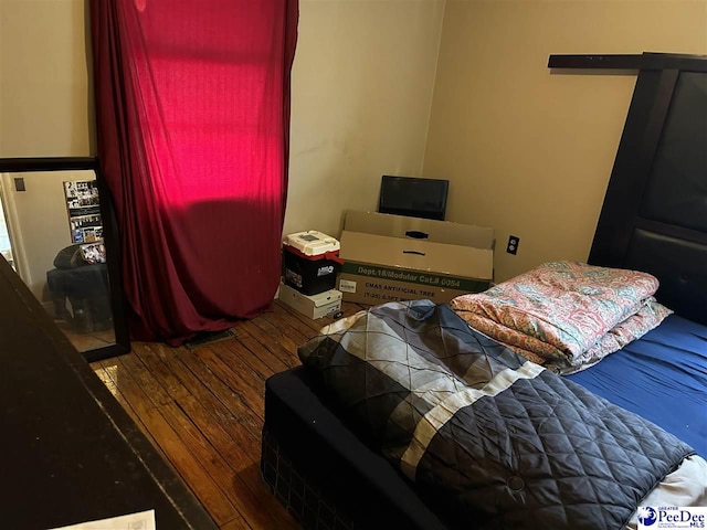 bedroom with hardwood / wood-style flooring