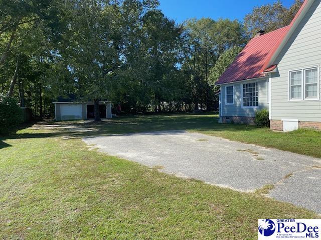 view of yard with a garage and an outdoor structure