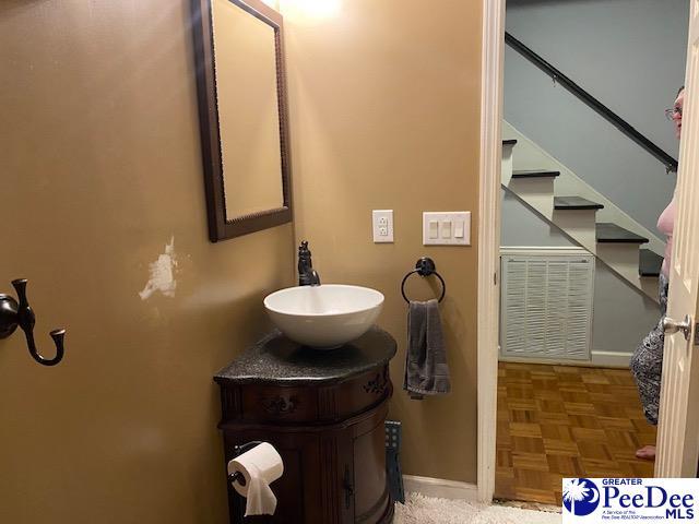 bathroom with vanity and parquet flooring