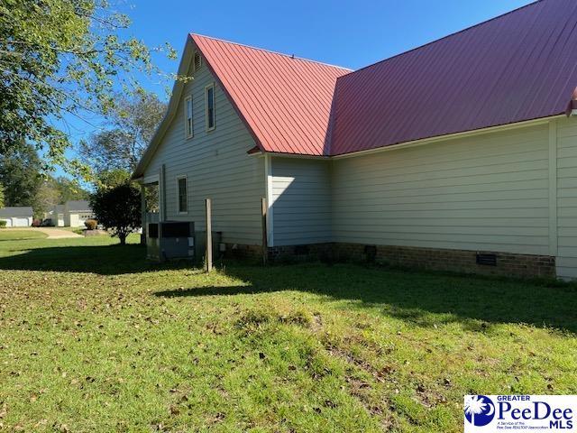 view of home's exterior featuring central AC unit and a lawn