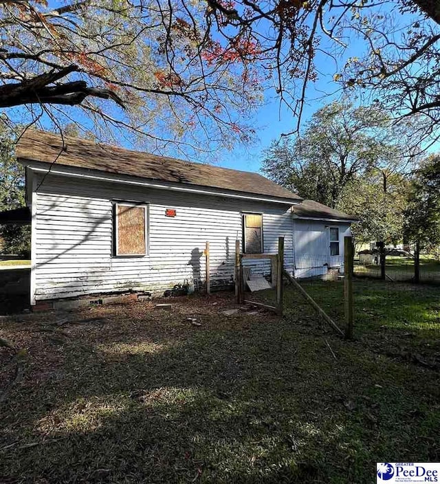 view of side of property with a yard