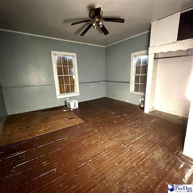 interior space with crown molding, dark wood-type flooring, and ceiling fan