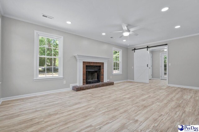 112 Gann Dr, Darlington, SC 29532 - unfurnished living room with a barn door, plenty of natural light, ornamental molding, ceiling fan, and recessed lighting