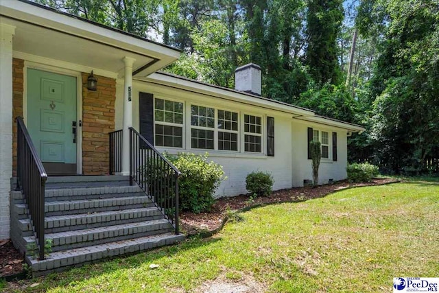 516 S Cashua Dr, Florence, SC 29501 - view of front of property with a front lawn and a chimney
