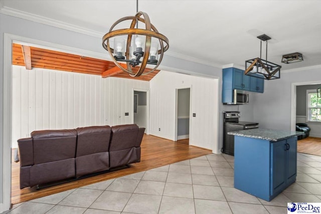 516 S Cashua Dr, Florence, SC 29501 - kitchen with blue cabinets, a chandelier, appliances with stainless steel finishes, light tile patterned floors, and ornamental molding