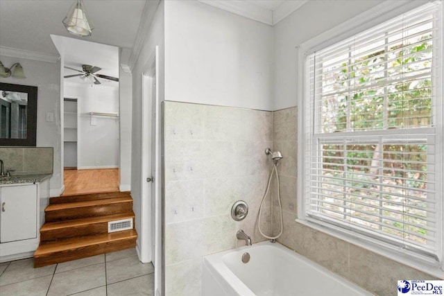 516 S Cashua Dr, Florence, SC 29501 - full bath with crown molding, vanity, tile patterned flooring, ceiling fan, and washtub / shower combination