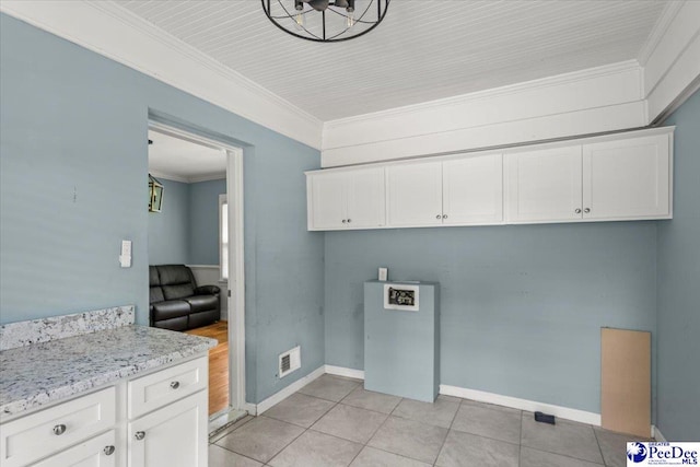 516 S Cashua Dr, Florence, SC 29501 - laundry room with ornamental molding and light tile patterned flooring