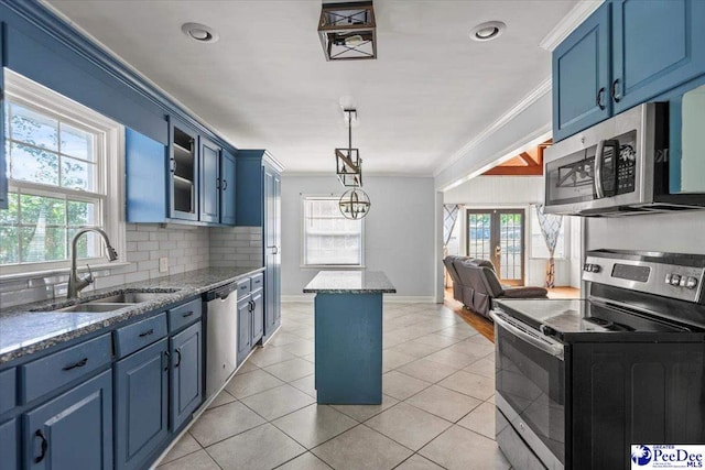 516 S Cashua Dr, Florence, SC 29501 - kitchen featuring appliances with stainless steel finishes, blue cabinetry, crown molding, decorative backsplash, and glass insert cabinets