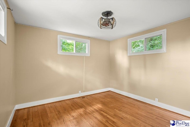 516 S Cashua Dr, Florence, SC 29501 - spare room featuring wood finished floors and healthy amount of natural light