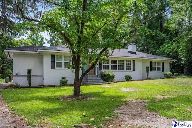 516 S Cashua Dr, Florence, SC 29501 - ranch-style home featuring a chimney, a front lawn, stucco siding, and entry steps
