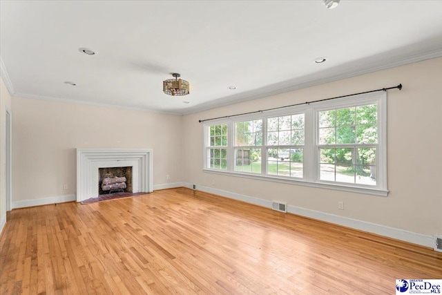 516 S Cashua Dr, Florence, SC 29501 - unfurnished living room with ornamental molding, light wood-type flooring, and a fireplace with flush hearth