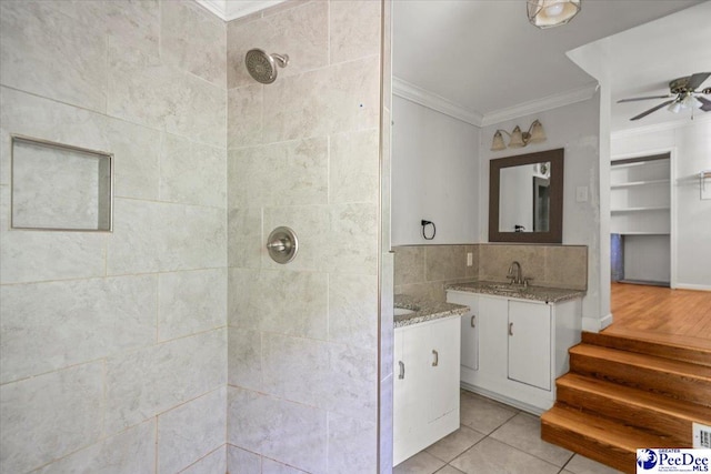 516 S Cashua Dr, Florence, SC 29501 - bathroom with ornamental molding, a tile shower, tile patterned flooring, vanity, and a ceiling fan
