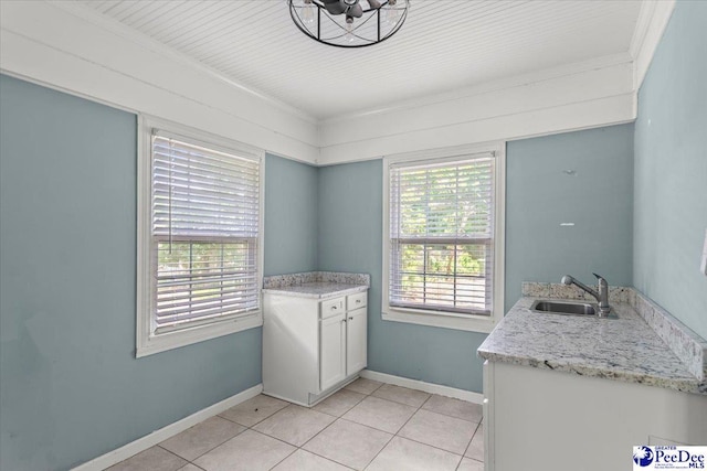 516 S Cashua Dr, Florence, SC 29501 - laundry room with light tile patterned flooring and ornamental molding
