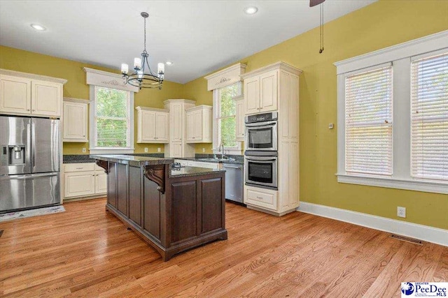302 Cashua St, Darlington, SC 29532 - kitchen featuring stainless steel appliances, a chandelier, a sink, decorative light fixtures, and light wood-style flooring