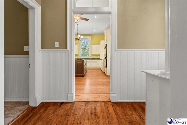 302 Cashua St, Darlington, SC 29532 - hallway featuring light wood-style flooring, a wainscoted wall, and baseboards