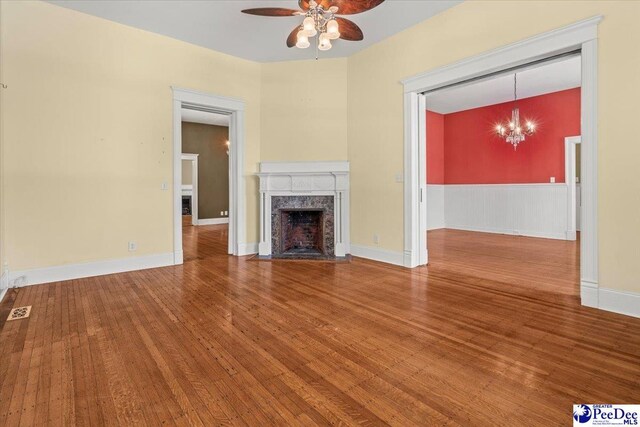 302 Cashua St, Darlington, SC 29532 - unfurnished living room featuring a ceiling fan, a chandelier, wood finished floors, and a fireplace