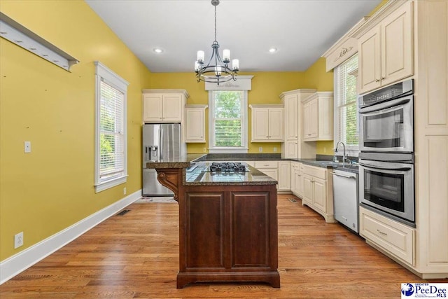 302 Cashua St, Darlington, SC 29532 - kitchen with stainless steel appliances, a chandelier, a center island, a sink, and decorative light fixtures