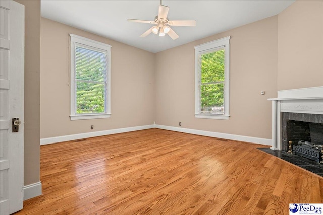 302 Cashua St, Darlington, SC 29532 - unfurnished living room with wood finished floors, ceiling fan, baseboards, and a tile fireplace