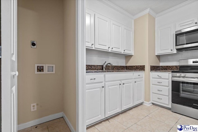 kitchen featuring sink, appliances with stainless steel finishes, white cabinetry, backsplash, and ornamental molding