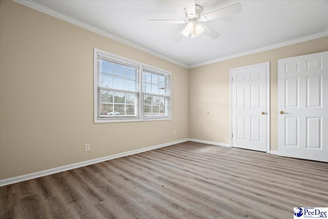 unfurnished bedroom with crown molding, hardwood / wood-style floors, and ceiling fan