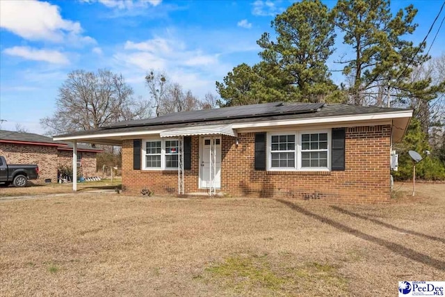 single story home with solar panels