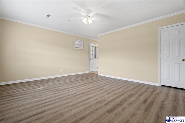 empty room featuring ceiling fan, ornamental molding, and wood-type flooring