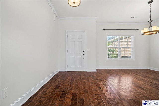 entrance foyer featuring crown molding, dark wood-type flooring, and a notable chandelier