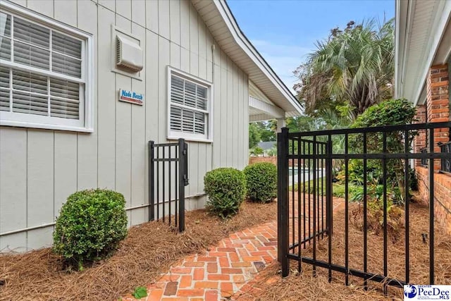 439 Whitman Ave, Florence, SC 29501 - view of exterior entry with a wall mounted air conditioner and a gate