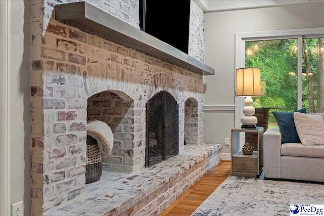 439 Whitman Ave, Florence, SC 29501 - living area with wood finished floors, crown molding, and a fireplace